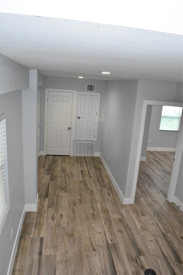 corridor featuring wood-type flooring