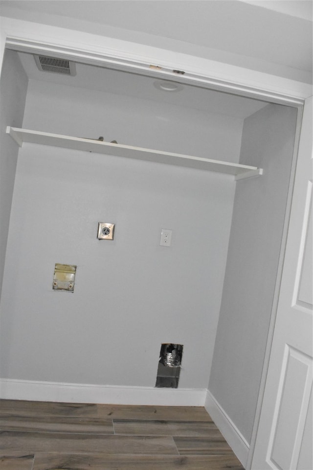 clothes washing area with hookup for an electric dryer, dark wood-type flooring, and washer hookup