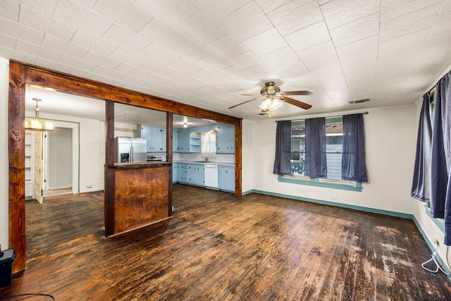 kitchen with ceiling fan, dark wood-type flooring, kitchen peninsula, stainless steel fridge, and white dishwasher