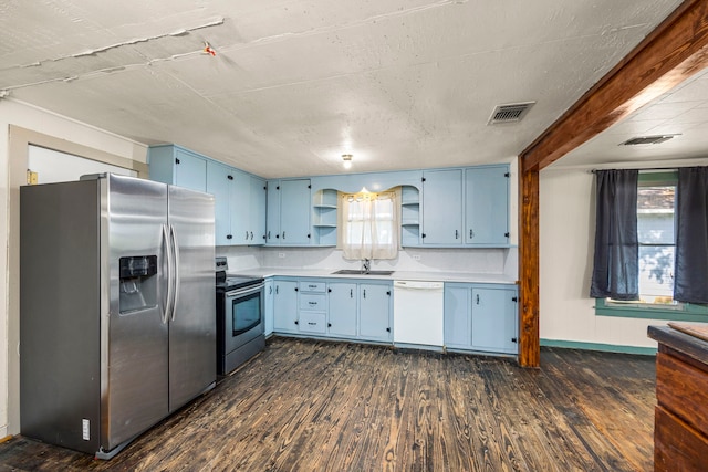 kitchen with dark hardwood / wood-style flooring, tasteful backsplash, stainless steel appliances, blue cabinets, and sink