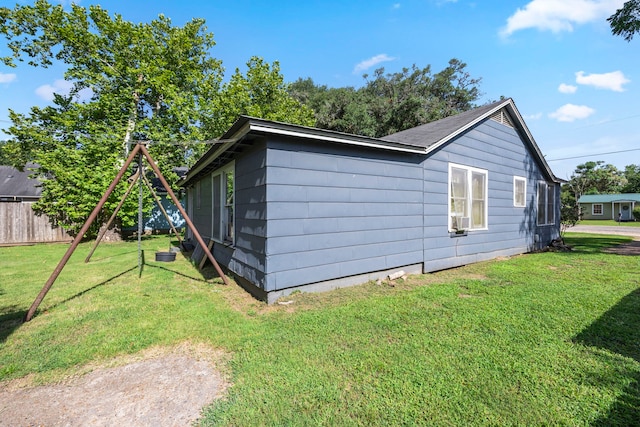 view of side of home with a yard