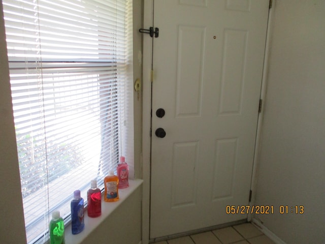 doorway featuring light tile patterned flooring