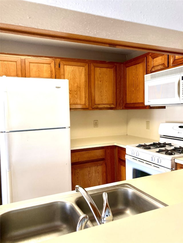 kitchen with white appliances and sink