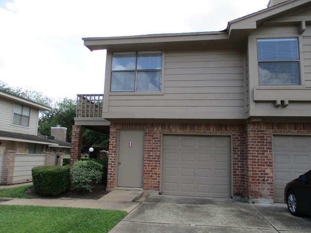 view of property with a balcony and a garage