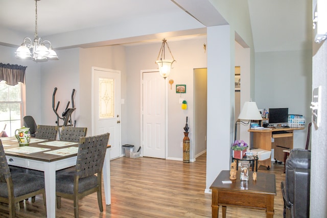 dining space with an inviting chandelier and hardwood / wood-style flooring