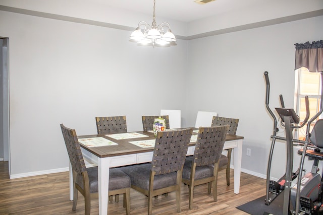 dining space with a notable chandelier and wood-type flooring