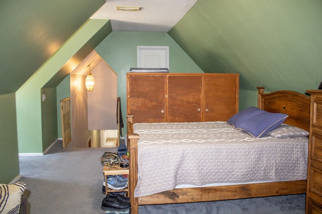 carpeted bedroom featuring lofted ceiling