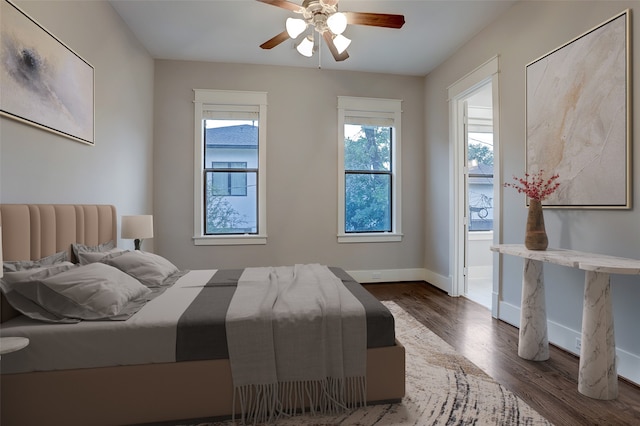 bedroom with ceiling fan and dark wood-type flooring