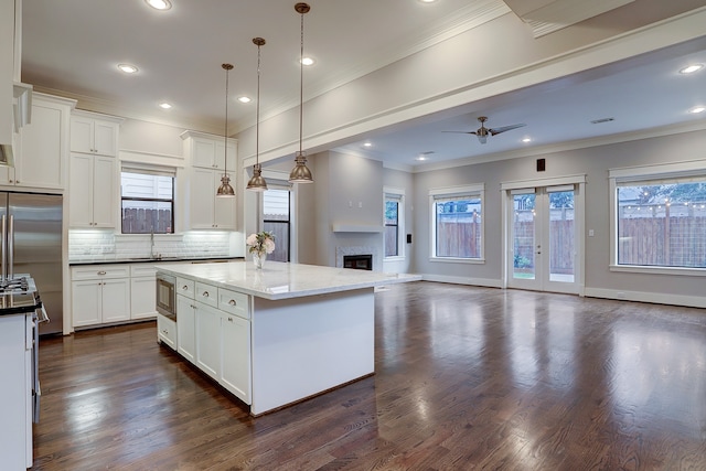 kitchen featuring dark wood-type flooring, backsplash, and a wealth of natural light