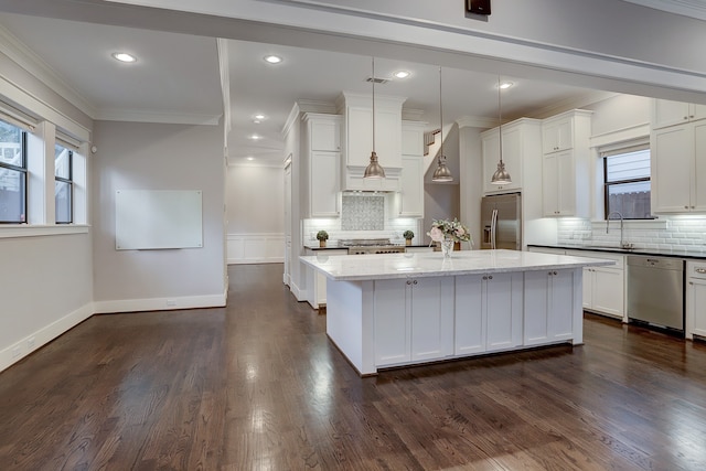 kitchen featuring appliances with stainless steel finishes, backsplash, dark hardwood / wood-style flooring, and plenty of natural light