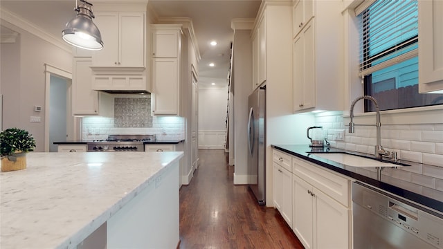 kitchen with crown molding, pendant lighting, dark hardwood / wood-style floors, appliances with stainless steel finishes, and backsplash