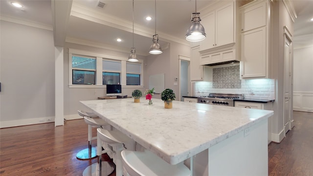 kitchen with decorative backsplash, stove, dark hardwood / wood-style floors, and a kitchen island