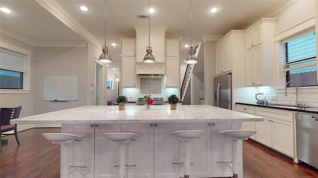 kitchen featuring decorative backsplash, dark hardwood / wood-style flooring, stainless steel appliances, and hanging light fixtures