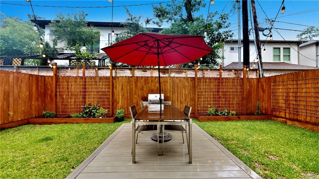 wooden terrace featuring a lawn