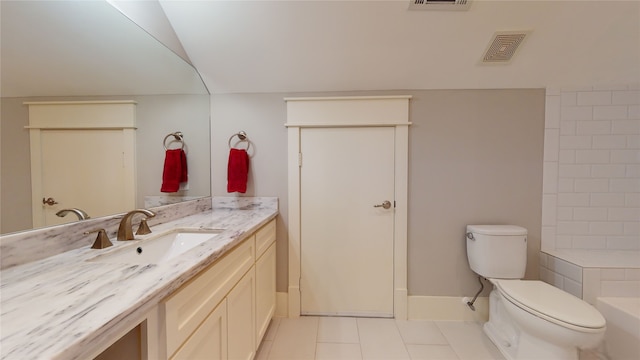 bathroom featuring tile patterned floors, vanity, and toilet