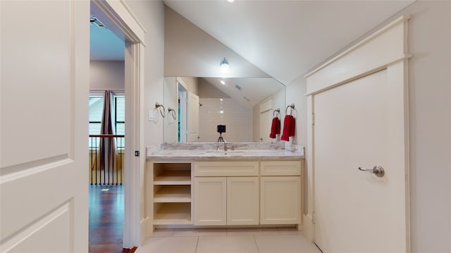 bathroom with lofted ceiling, vanity, and wood-type flooring