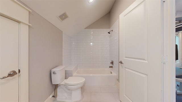 bathroom featuring tile patterned floors, lofted ceiling, toilet, and tiled shower / bath