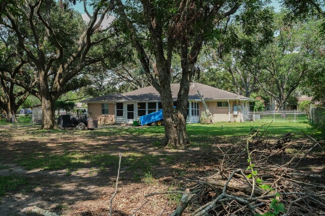 rear view of house with brick siding and fence