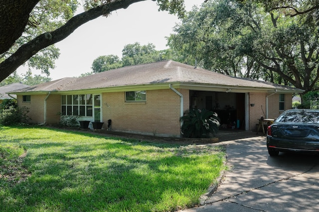 view of property exterior with a garage, a yard, brick siding, and concrete driveway