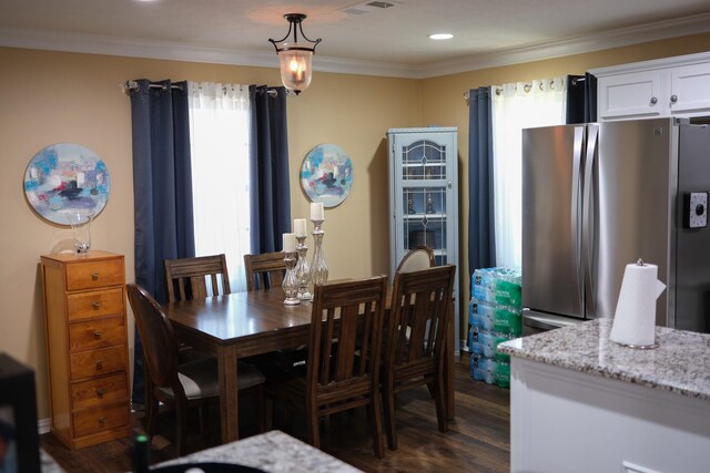 dining room featuring dark hardwood / wood-style floors and ornamental molding