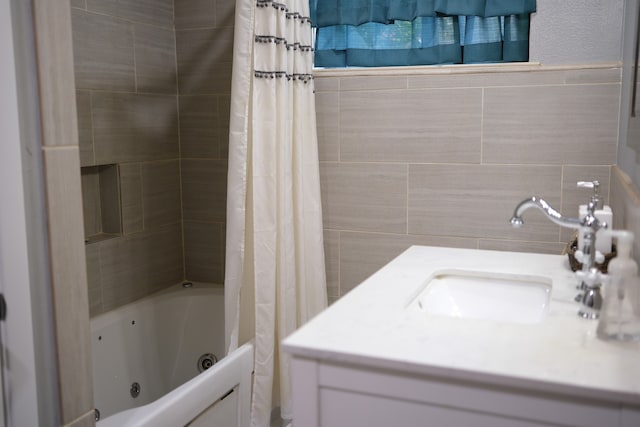 bathroom with shower / tub combo, sink, and tile walls