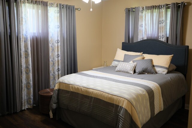 bedroom featuring dark wood-style floors and multiple windows