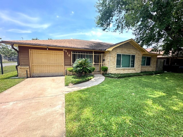 ranch-style house featuring a garage and a front lawn