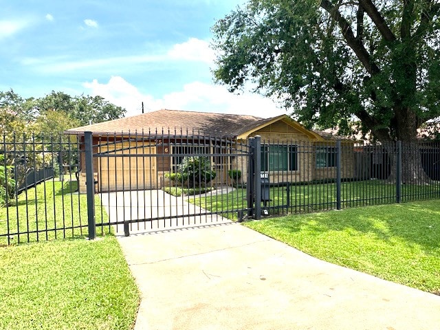 view of gate with a lawn and a garage