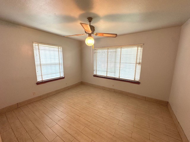 spare room featuring ceiling fan and light hardwood / wood-style flooring