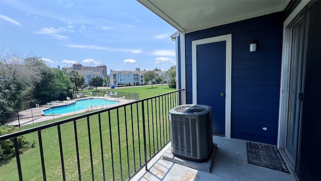 balcony featuring a fenced in pool and central air condition unit