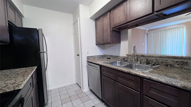 kitchen with dishwasher, dark brown cabinets, sink, light tile patterned flooring, and refrigerator