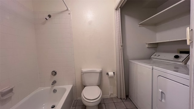 full bathroom with tiled shower / bath, washing machine and clothes dryer, toilet, vanity, and tile patterned flooring