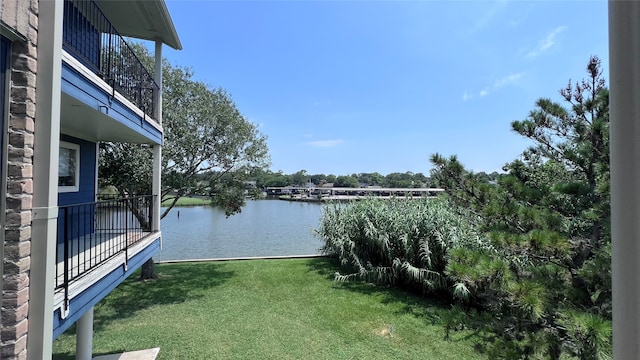 view of yard featuring a balcony and a water view