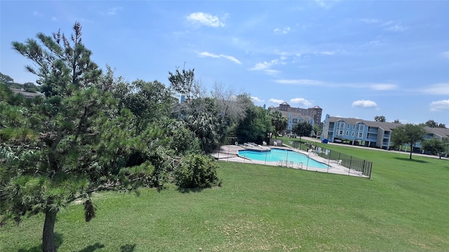 view of pool with a lawn