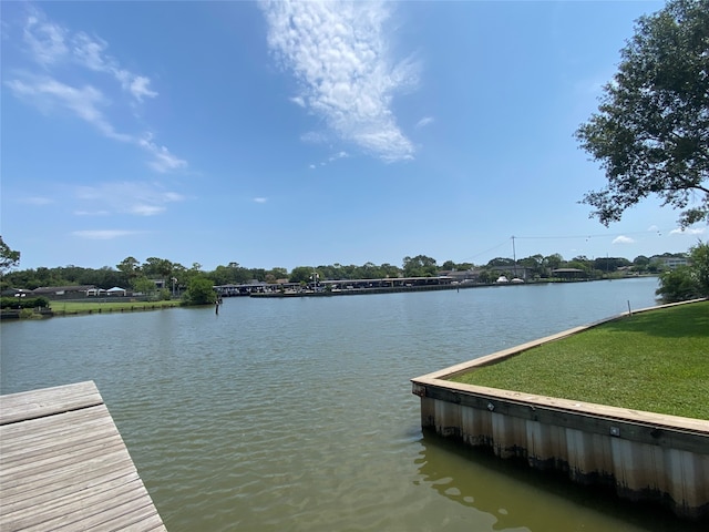 dock area featuring a water view and a yard