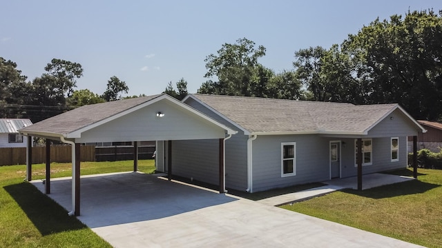 ranch-style house featuring a front yard and a carport