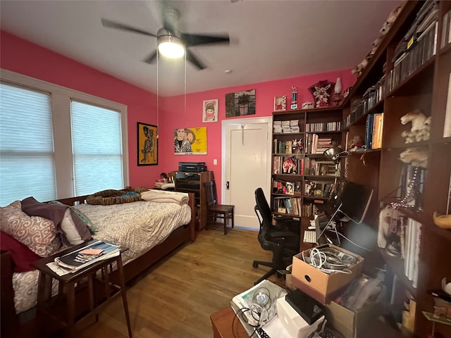 bedroom with ceiling fan and hardwood / wood-style flooring