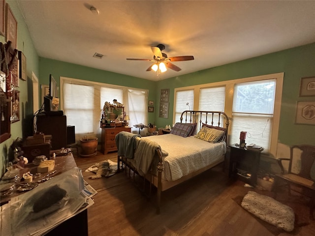 bedroom featuring ceiling fan and dark hardwood / wood-style flooring