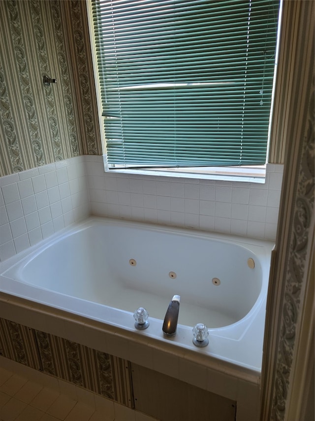 bathroom featuring plenty of natural light and a bath