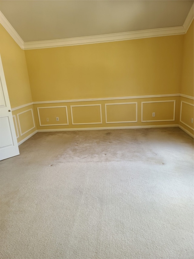 unfurnished room with ornamental molding and light carpet