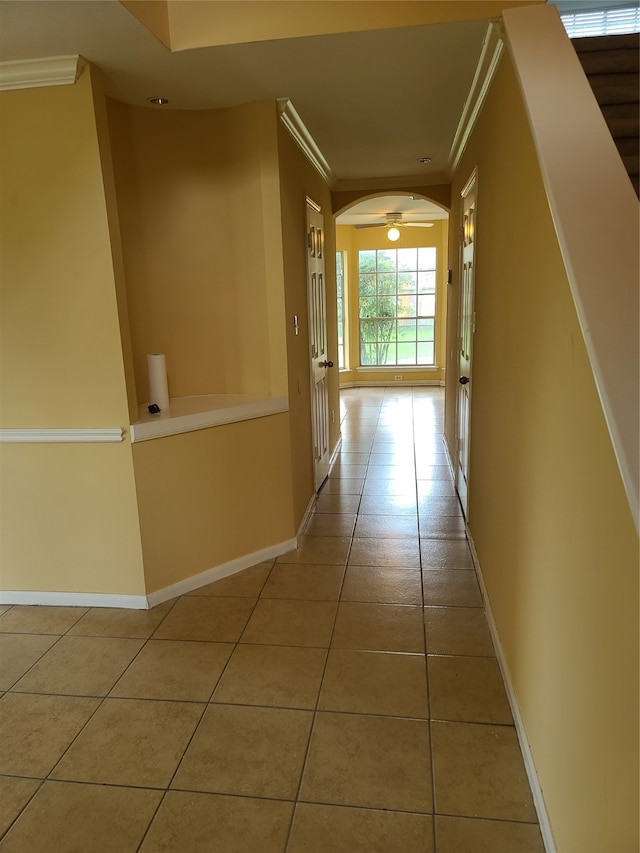 corridor featuring tile patterned flooring and crown molding