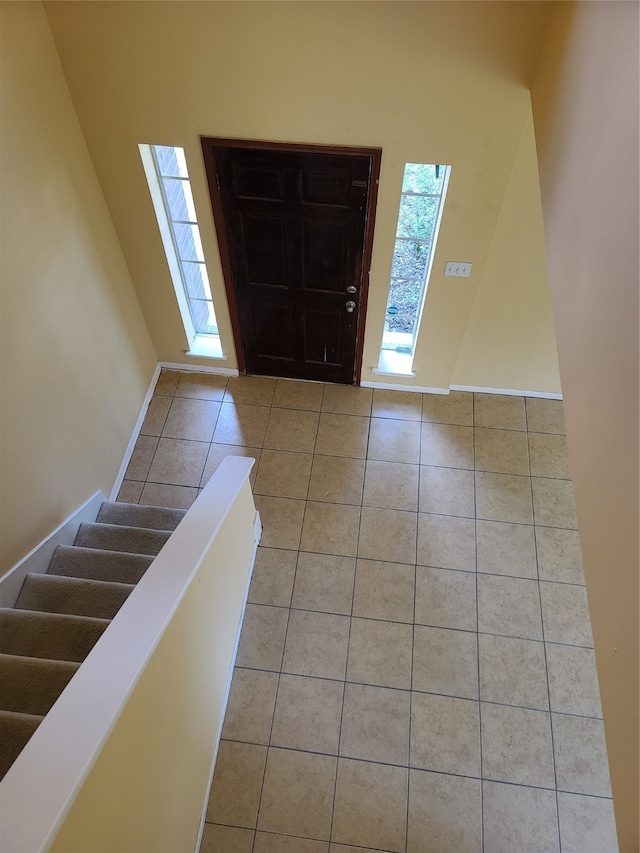 tiled foyer featuring a high ceiling