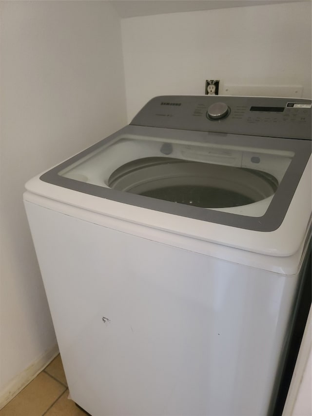 interior details featuring washer / clothes dryer and tile patterned floors