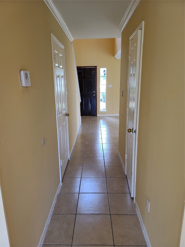 hall featuring ornamental molding and tile patterned flooring