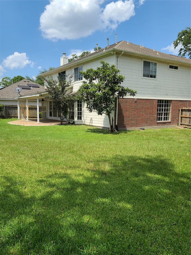 back of house with a lawn