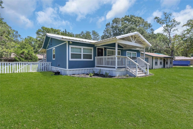 rear view of house featuring a lawn