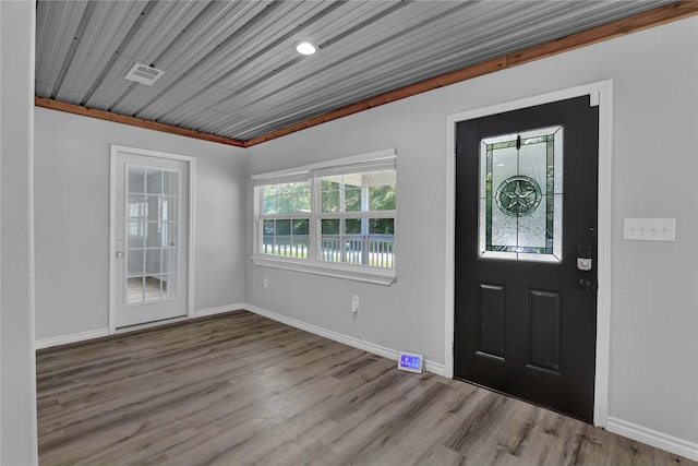 entrance foyer featuring wood-type flooring and ornamental molding