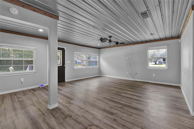 unfurnished room featuring hardwood / wood-style floors, ceiling fan, and a wealth of natural light