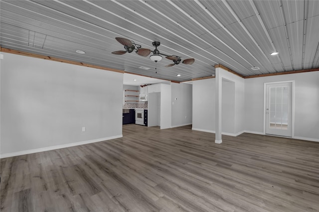 unfurnished living room with ceiling fan, hardwood / wood-style floors, and crown molding