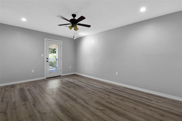 empty room with hardwood / wood-style floors and ceiling fan